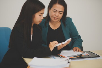 Pretty Asian female lawyer working and hammer, laptop, justice advice and legal concept. In office