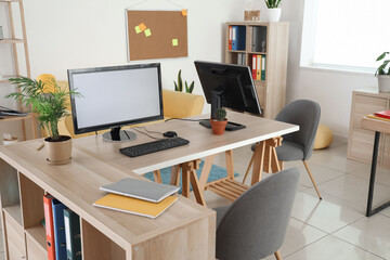 Modern workplace with computer monitors in stylish office