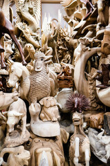 Various handmade wooden statues and carvings at Sukawati Art Market, showcasing intricate craftsmanship and traditional Balinese designs. Culture, art, travel, and souvenirs for tourist