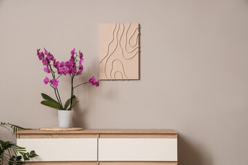 Orchid flower on commode in light room