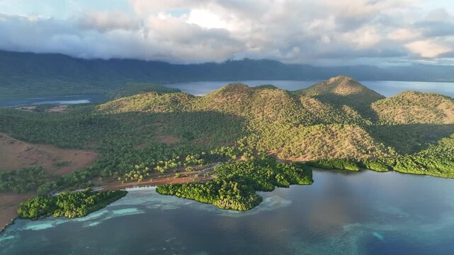 Morning sunlight illuminates the mangrove-fringed island of Lembata, Indonesia. This beautiful and biodiverse area is part of the famed Ring of Fire and is home to high marine biodiversity.