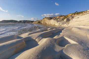 View of white rock cliff Stairs of the Turks or Scala dei Turchi at the mediterranean coast during golden hour at sunset, Realmonte, Sicily, Italy