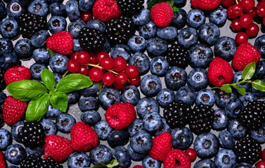 Berry background. Texture of fresh wild berries. Garden berry. Summer berry fruit. Raspberry, blueberry, blackberry.