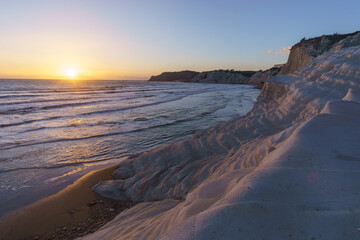 White rock cliff called Stairs of the Turks or Scala dei Turchi at the mediterranean sea coast with beach during sunset, Realmonte, Sicily, Italy