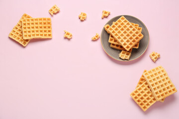 Plate with tasty Belgian waffles on pink background