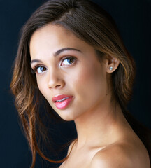 Fototapeta premium Woman, beauty and serious portrait in studio with makeup, glowing skin and pride for dermatology treatment. Model, cosmetics and person with confidence, wellness and self care on dark background