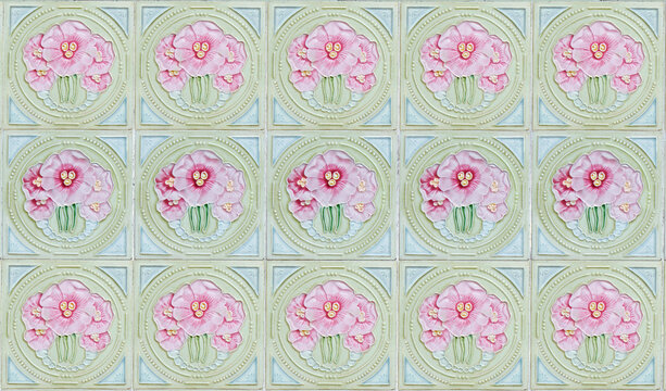 Rows of antique Nyonya Tiles with pink flowers with green background. Vintage Baba and Nyonya style floral tile pattern in penang. Traditional Peranakan cultural in Malaysia.