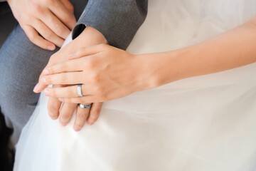 Newlyweds with rings sitting on their wedding day, closeup