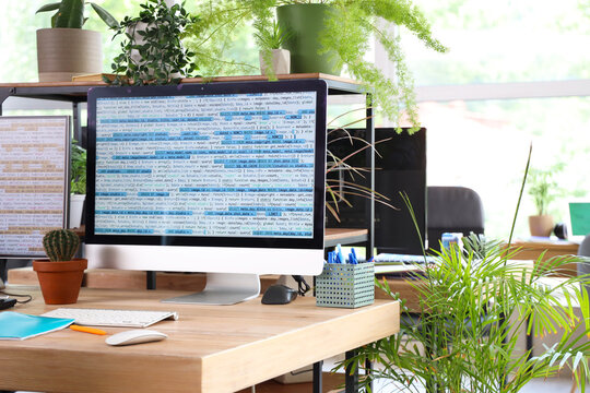 Programmer's workplace with computer monitors in office