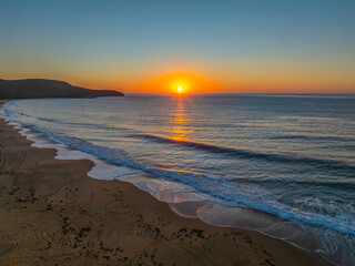 Sunrise seascape with clear skies and orange horizon