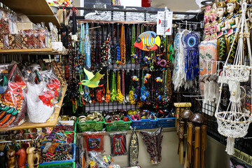 Various types of handmade souvenirs for sale at Sukawati Art Market in Gianyar, Bali. From intricate wood carvings, wooden masks, and colorful paintings to beautiful textiles and unique jewelry