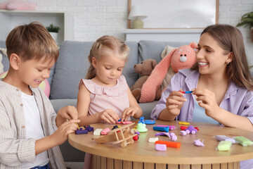 Obraz premium Cute little children with their mother sculpting from plasticine at home