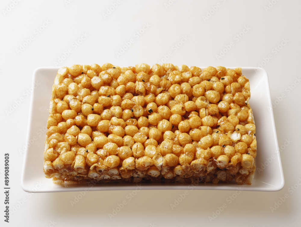 Sticker Close-up of Gangjeong(Sweet Rice Puffs) with rectangular shape on white dish, South Korea
