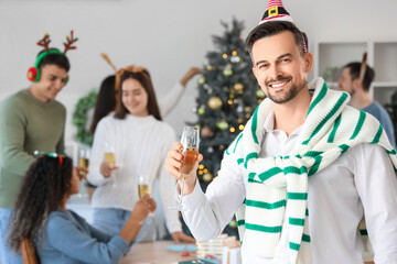 Businessman with champagne celebrating New Year at party in office
