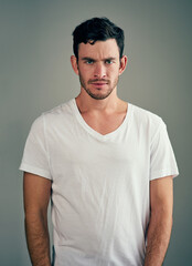 Fototapeta premium Portrait, studio and anger of man, serious and annoyed with scholarship in university, unhappy and moody. White background, upset and rejection of student loan for education in college in Germany