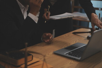 Judge gavel with Justice lawyers having team meeting at law firm background. Concepts of Law and Legal services.