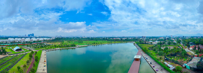 Aerial view of Bicentenario Park in Mexico City, showcasing its tranquil pond reflecting the soft,...