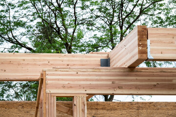 Closeup detail of new house construction, wall wood framing started and glue laminate header beam...