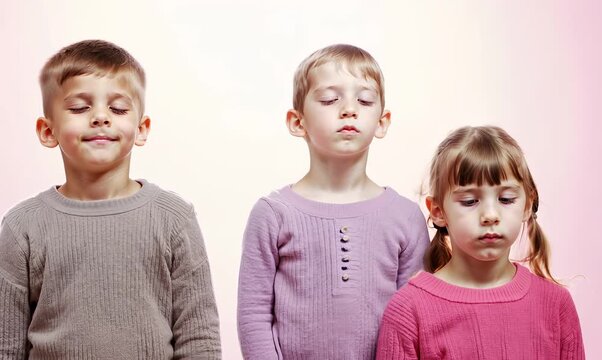 Group portrait video of children practicing mindfulness, sophrology, relaxation & stress-reduction wearing a cozy sweater on pastel background