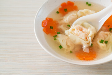 shrimp dumpling soup in white bowl