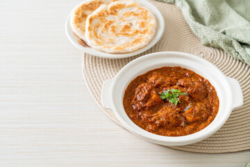 chicken tikka masala spicy curry meat food with roti or naan bread