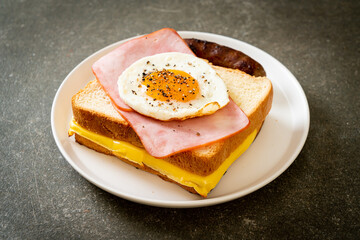 bread toasted cheese topped ham and fried egg with pork sausage