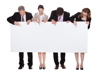 Four happy business professionals holding a blank signboard for advertising