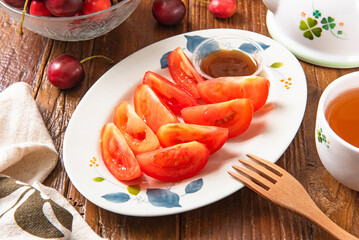  Sliced red tomato with brown sugar ginger dipping sauce is a popular way of eating in Taiwan