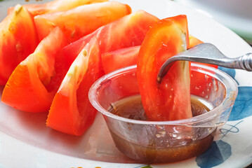  Sliced red tomato with brown sugar ginger dipping sauce is a popular way of eating in Taiwan
