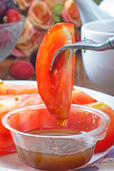  Sliced red tomato with brown sugar ginger dipping sauce is a popular way of eating in Taiwan