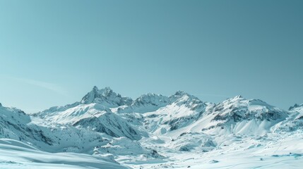Obraz premium A picturesque mountain range covered in snow with a clear blue sky above.
