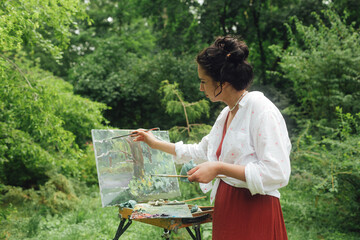 Female artis paints a picture in the park. Mindfulness, art therapy, creativity concept. Process of plein air painting in nature. A series of photos showing the step-by-step creation of a painting