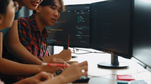 Back end software developer engineer for computer programming working together on debugging writing computing code, solving complex algorithms display on monitor in office. Burgeoning