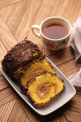 A roll cake is a sponge cake baked in a shallow pan, filled with jam or buttercream and then rolled. Roll cakes are often known as jam rolls, or jelly rolls in the United States. mocha. bolu meranti.