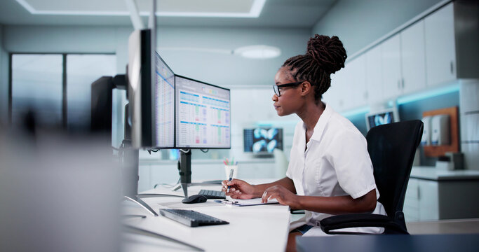Hospital Doctor Using Spreadsheet For Billing Codes On Desktop - Powered by Adobe