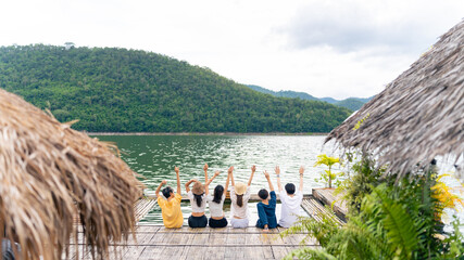 Group of Young Asian man and woman enjoy and fun outdoor lifestyle travel nature forest mountain on summer holiday vacation. Happy generation z people friends relaxing together on lake house balcony. © CandyRetriever 