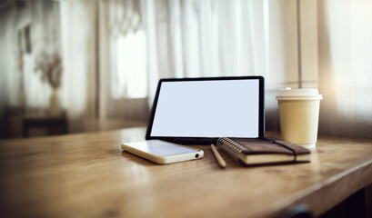 Comfortable workplace on wooden table with coffee cup, mobile phone, tablet and diary book. work part time job and relax in cafe, vintage color tone and retro style