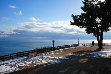 snowy walkway at seaside cliff