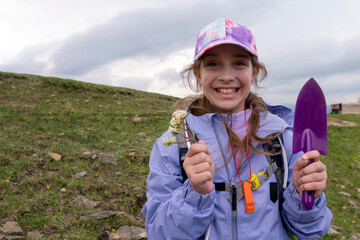 Girl receiving flowers in wearing a rain jacket
