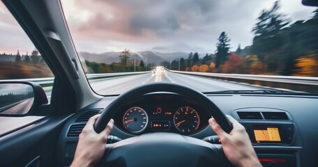 The driver point-of-view perspective from a driving car on a highway asphalt, captures the sense of motion and travel