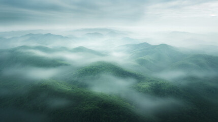 Obraz premium A misty, foggy mountain range with trees and mountains in the background