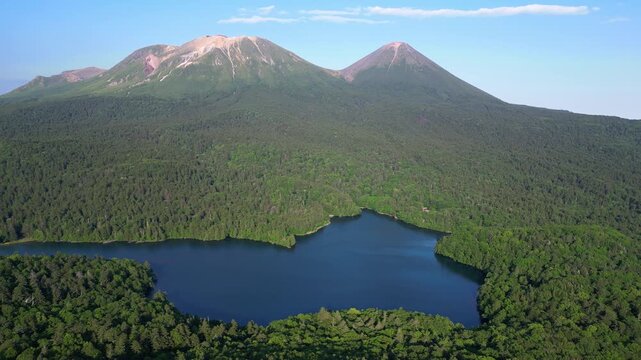 Mt Meakan, Hokkaido: Aerial drone footage of the lake Onneto at the foot of the Mt Meakand and Akan Fuji volcano in Hokkaido on a sunny summer day in Japan.