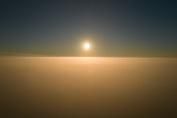 Amazing natural scenery. The camera rises out of the thick fog over a beautiful ocean of clouds at sunrise.