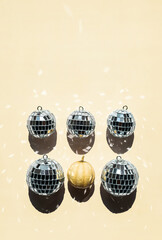 Arrangement of disco balls and tiny pumpkin.