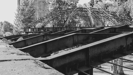 Massive metal beams of unfinished construction in black and white