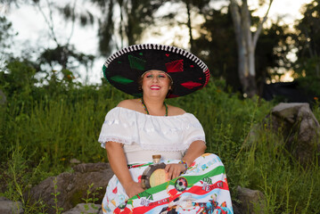 Woman with Mexican hat in rural scenery. Celebration of the Independence Day in Mexico.