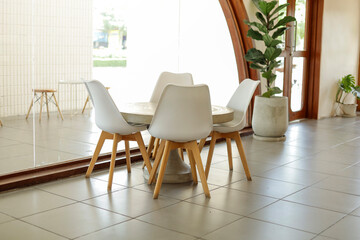 The interior decoration of the seating area in the cafe is minimalist in style.