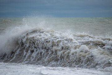 Seashore, small stones, sea wave. Marine background.