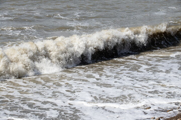 foamy coastal sea wave of a pebble beach