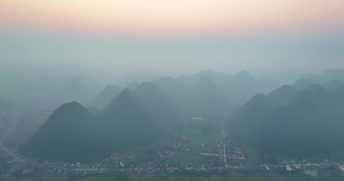 Landscape of Bac Son valley around in the morning with houses on pitotis in the village mountains view in Lang Son, Vietnam